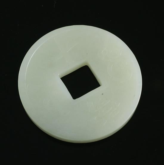 A Chinese pale celadon jade model of a Kangxi coin, 5.2cm